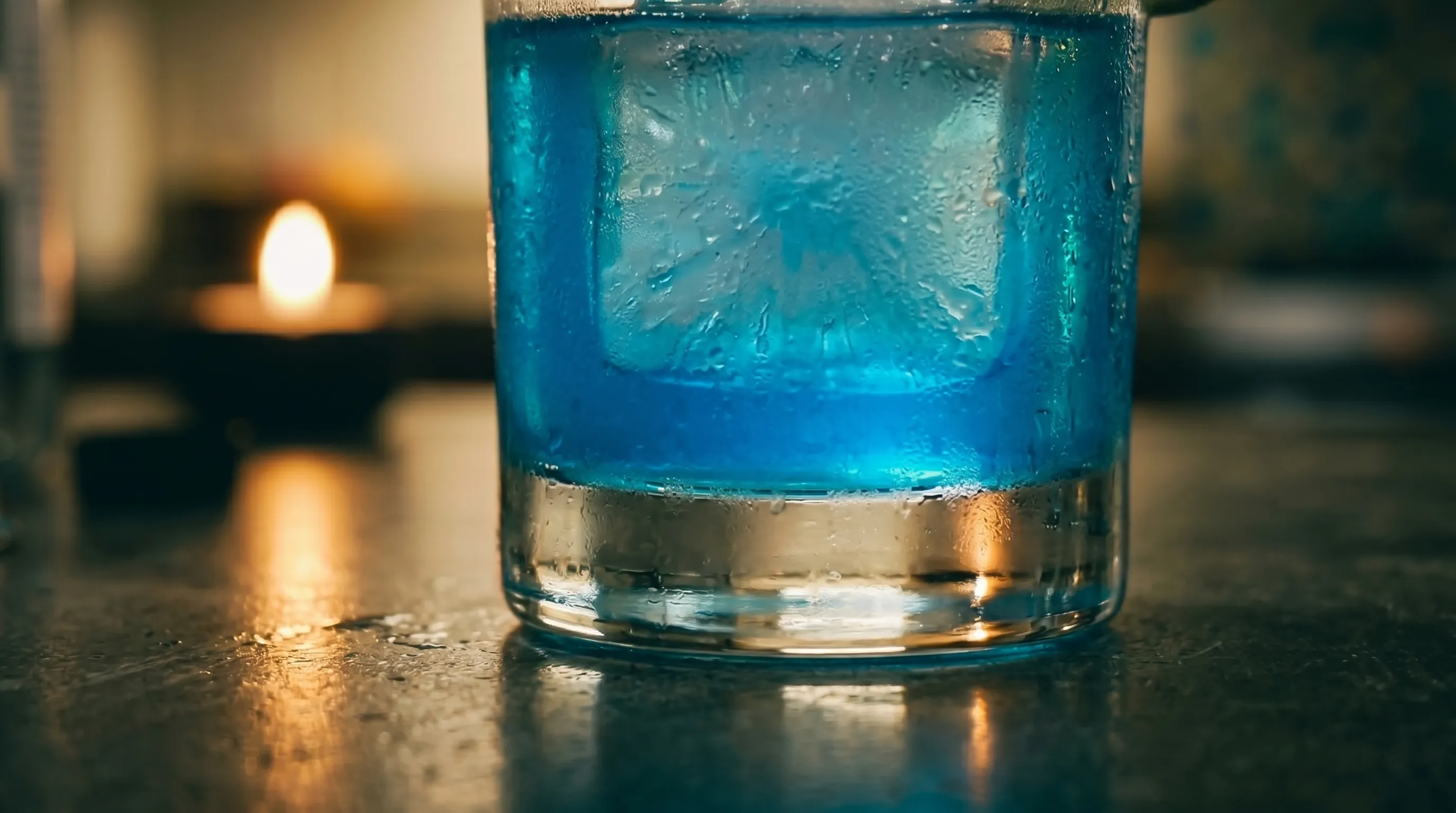 Just the bottom half of my glass with warm candle bokeh blurred behind